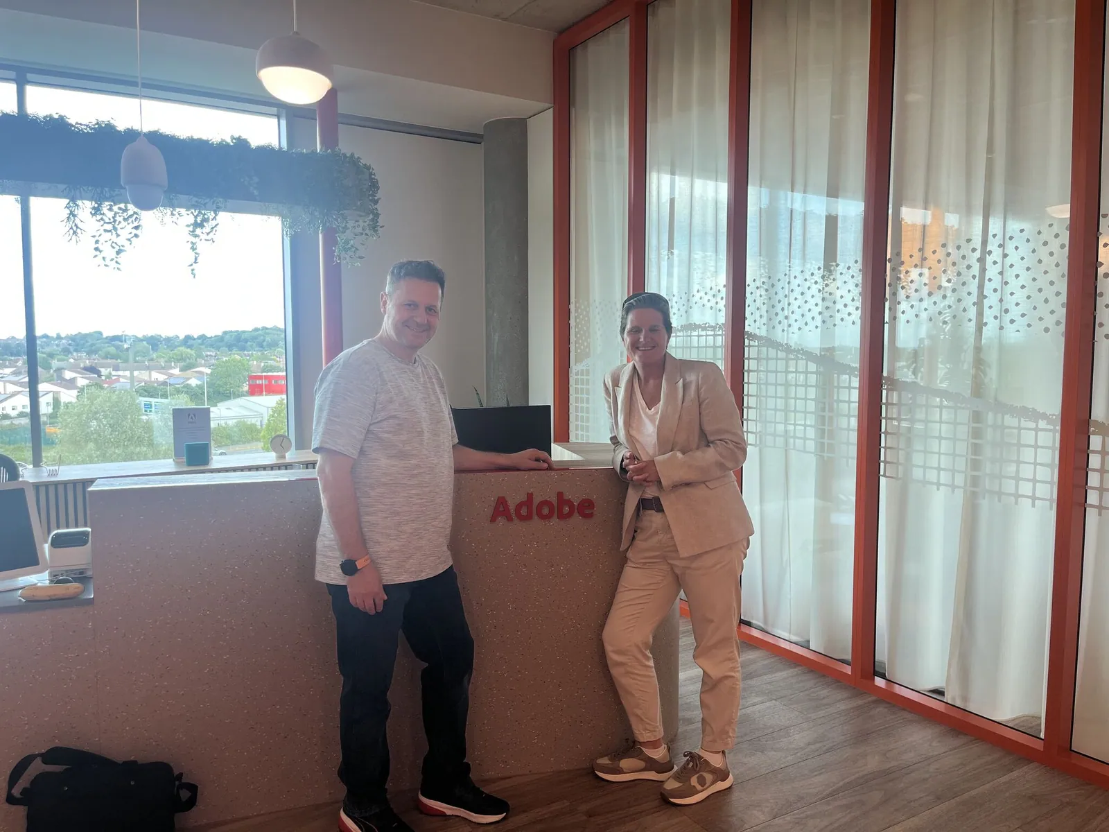 Rebecca Jones, CEO, and Laszlo, Senior Developer, at the Adobe office in Reading