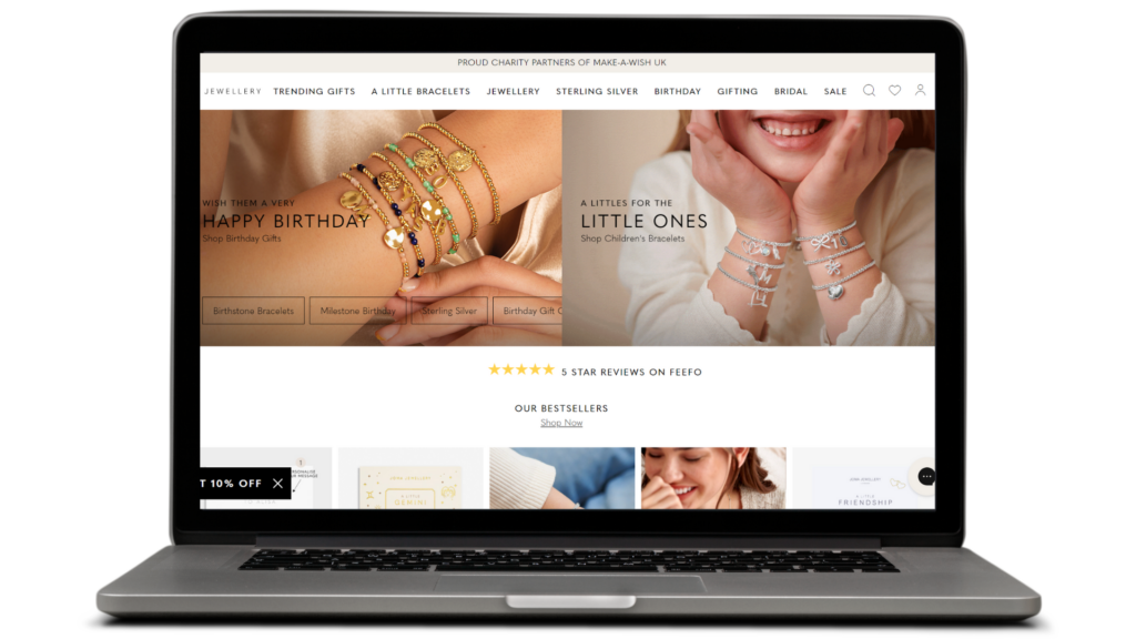 Laptop showing Joma Jewellery home page on Adobe Commerce Cloud
