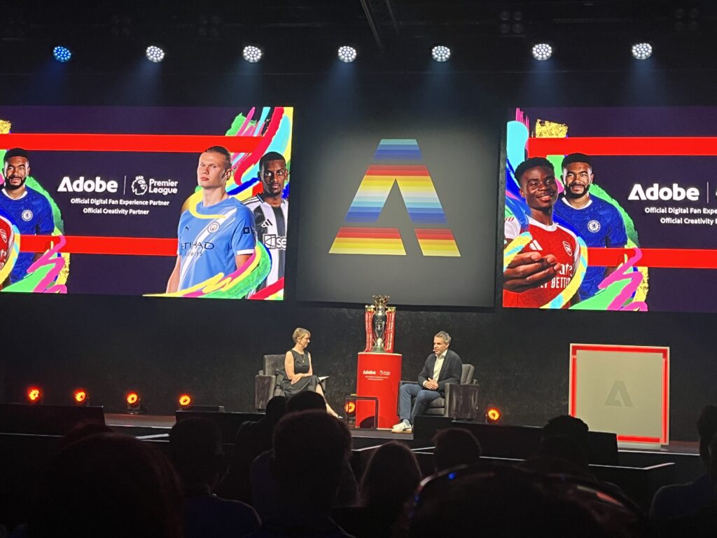 Image showing Adobe and the Premier League representatives talking on stage. The Premier League was a big client win for Adobe and they invited them to the stage to talk about their partnership.
