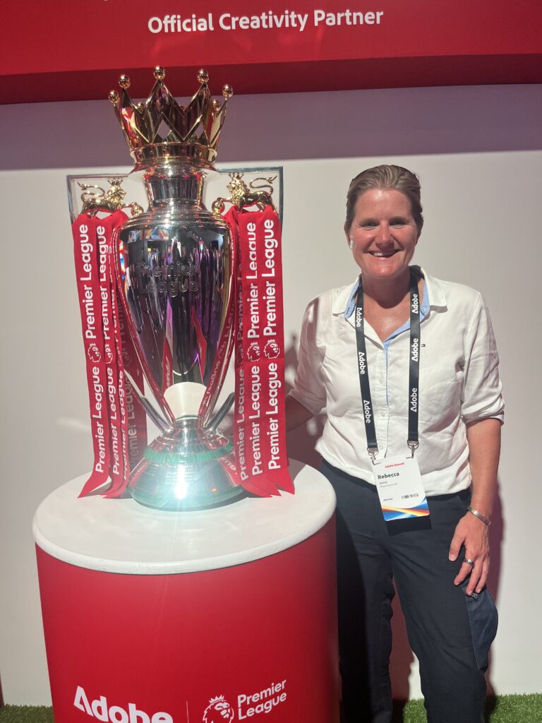An image of Rebecca Jones, objectsource CEO, with the Premier League trophy at Adobe Summit London - The Premier League was a big client win for Adobe and they invited them to the stage to talk about their partnership.